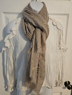 Woman's lightweight cream colored scarf with gold flecks